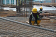 © Aisyaqilumar - MALACCA, MALAYSIA -MAY 16, 2016: Construction workers fabricating steel reinforcement bar at the construction site in Malacca, Malaysia. The reinforcement bar was tied together using tiny wire.