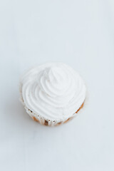 Wall Mural - homemade muffins with white cream on a light background.