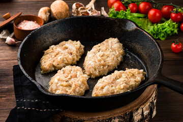 Sticker - Chicken cutlets in a pan on a dark concrete table background