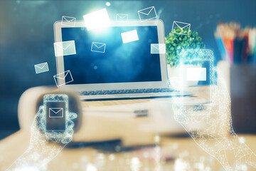 Desktop computer background in office and flying envelops hologram drawing. Multi exposure. Electronic mail concept.