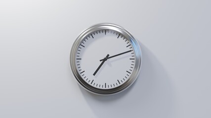 Glossy chrome clock on a white wall at twelve past seven. Time is 07:12 or 19:12