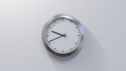 Glossy chrome clock on a white wall at forty-one past nine. Time is 09:41 or 21:41