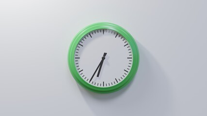 Glossy green clock on a white wall at thirty-five past six. Time is 06:35 or 18:35