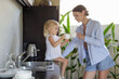 © triocean - Mother and daughter in kitchen preparing tea. Family time, domestic life, time at home