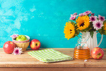 Jewish Holiday Rosh Hashana Background With Honey Jar, Apples And Sunflowers On Wooden Table. Kitchen Counter With Tablecloth And Copy Space For Product Display