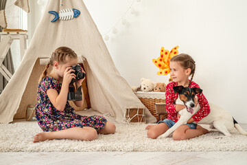 Wall Mural - Little girl taking pictures of friend