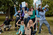 © Roman - diverse mixed race people with posters agitating Marijuana being legal, group of youth in the park, holding placards and megaphone loudspeaker