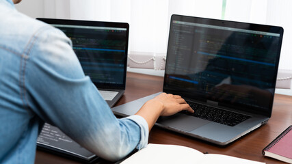 Wall Mural - programmer or software developer typing new lines of code, coding technologies working at wooden ind