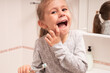 © Stanislaw Mikulski - Cute little girl brushing her teeth in the bathroom