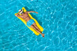 © New Africa - Young man with inflatable mattress in swimming pool, top view. Space for text