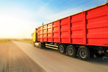 Wall Mural - Logistics concept. Truck on country road, motion blur effect