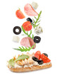 © New Africa - Tasty bruschetta with flying ingredients on white background