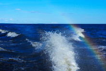Trail From A Motor Boat Racing At High Speed, Water Splash, Rainbow