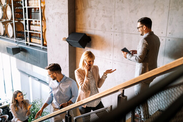 Busy business people on stairs in modern office