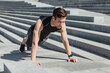 © Prostock-studio - Active leisure and motivation. Guy with fitness tracker push up the city stairs