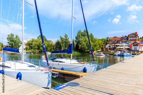 Yacht boats at pier in sailing port Nowe Guty on Lake Sniardwy on summer sunn...