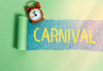 Handwriting text writing Carnival. Conceptual photo traveling enterprise offering amusements, exhibitions, etc. Rolled ripped torn cardboard placed above a wooden classic table backdrop