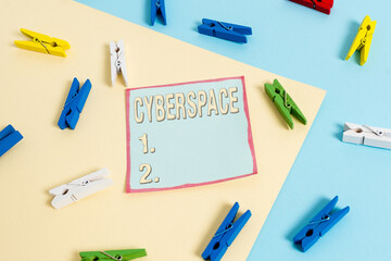 Word writing text Cyberspace. Business photo showcasing the online world of computer networks and especially the Internet Colored clothespin paper empty reminder yellow blue floor background office