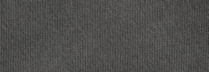 The fabric texture is fluted grey.The background of dense dark-gray patterned fabric.