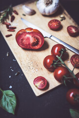 Wall Mural - raw tomatoes on cutting wood board