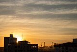 Fototapeta  - sunset over the city silhouette