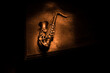 © zef art - Alto gold sax miniature with colorful toned light on foggy background. Saxophone music instrument in lowlight. Selective focus