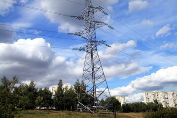 power line pole against a blue sky with clouds