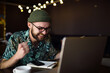 © mykolastock - Happy excited male hipster looking at laptop celebrating victory and smiling