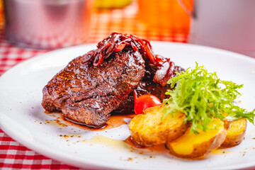 Wall Mural - Grilled beef steak served with potato on white plate. Close up