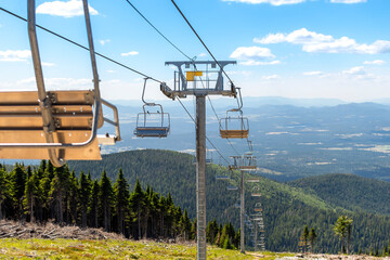 An empty ski lift not operating during summer at the Mt Spokane State Park ski resort overlooking the Spokane, Washington area, USA