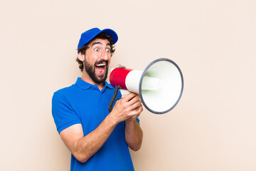 Wall Mural - young cool bearded man with a megaphone. delivery man concept