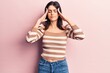 © Krakenimages.com - Young beautiful girl wearing casual striped t shirt with hand on head, headache because stress. suffering migraine.