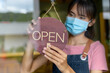 © PK Studio - New generation women wearing a mask to do small business in coffee shop counter Opening a shop