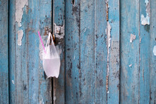Ice Bags Hanging At The Old Wooden Door