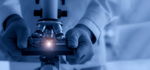 Wall Mural - laboratory concept; the scientist uses the microscope for research in a laboratory.