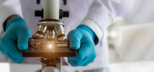 Wall Mural - laboratory concept; the scientist uses the microscope for research in a laboratory.