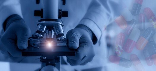 Wall Mural - laboratory concept; the scientist uses the microscope for medical research in a laboratory.
