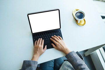 Top view mockup image of a woman using and typing on tablet keyboard with blank white desktop screen as a computer pc