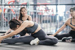 © Kiattisak - Group of sporty asian women warming up stretching exercises pre-workout