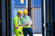 © visoot - Two foreman workers discussing and checking in shipping yard at container cargo.