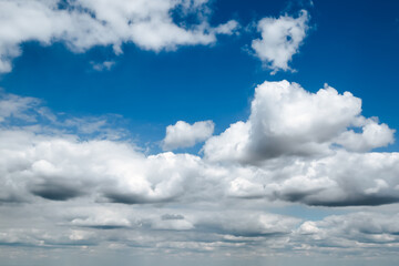 Wall Mural - a landscape of fluffy clouds of white light against a bright blue sky