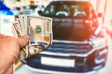 Men Holding Lot Of 100 Dollar Bills For Buy Or  Rent A New Car