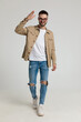© Viorel Sima - happy young casual guy in jacket military saluting and smiling