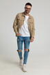 © Viorel Sima - happy young casual man in jacket walking and smiling