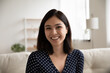 © fizkes - Close up headshot portrait of smiling Vietnamese young woman look at camera talk on video call, profile picture of happy millennial Asian girl engaged in webcam conference or virtual event at home