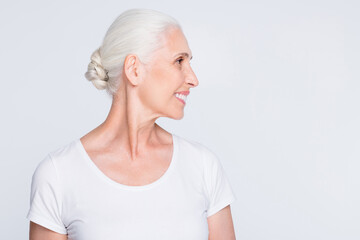 Close-up profile side view portrait of her she nice-looking attractive lovely well-groomed content cheerful cheery gray-haired middle aged lady isolated over light white grey pastel background