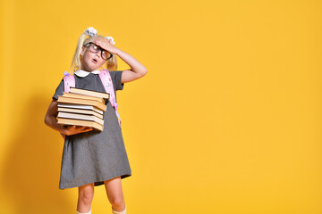 Elementary school girl with books tired of studying