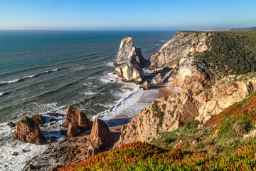 Wall Mural - Cliffs and the ocean, the rocky coast of Atlantic ocean at sunset in Portugal near the Cape Roca (Cabo da Roca). Travel Portugal.