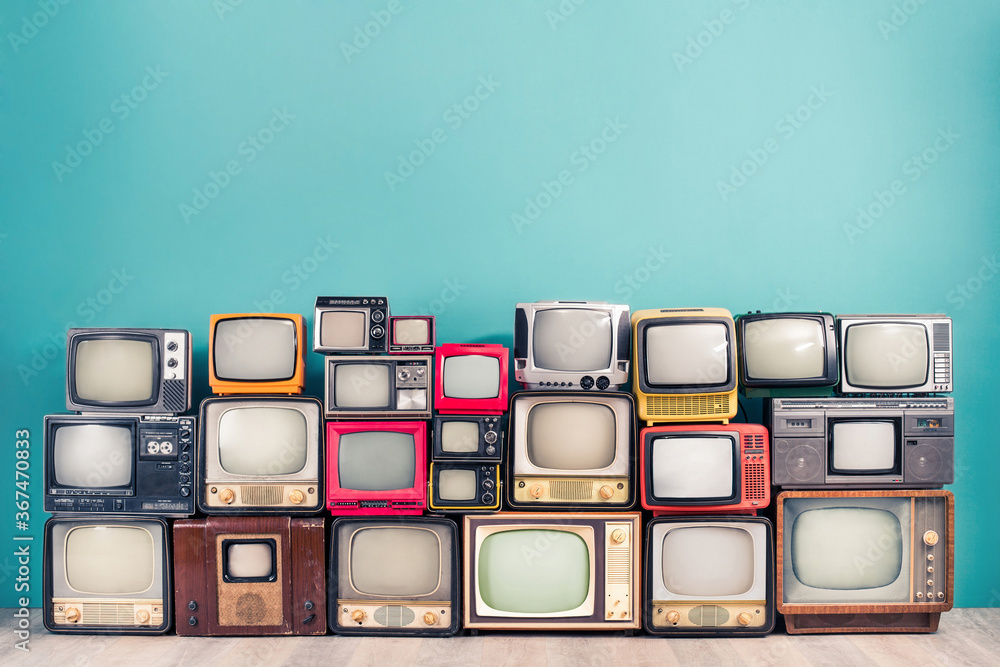 Classic retro CRT TV receivers set collection from circa 50s, 60s, 70s and 80s of XX century front mint blue wall background. Media broadcasting or live news concept. Vintage old style filtered photo - obrazy, fototapety, plakaty 