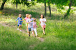 © master1305 - Kids, children running on meadow in summer's sunlight. Look happy, cheerful with sincere bright emotions. Cute caucasian boys and girls. Concept of childhood, happiness, movement, family and summer.